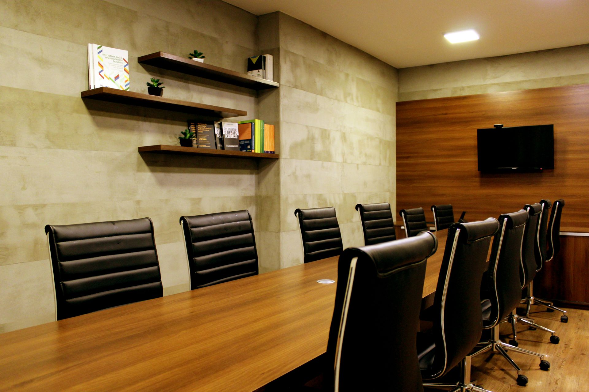 A boardroom with leather chairs and wood panelling